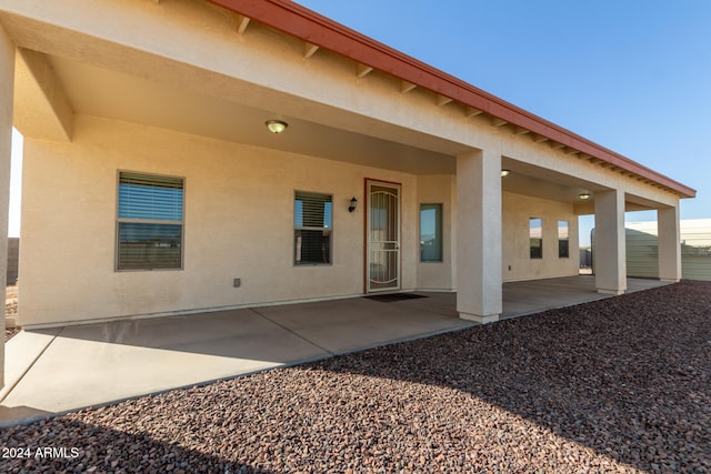 back of property with a patio