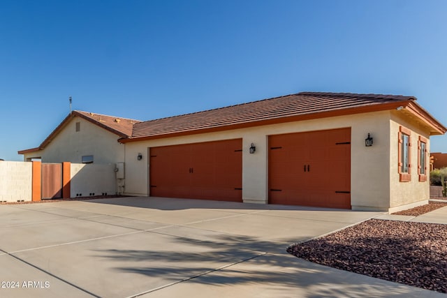 view of side of home featuring a garage