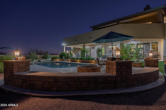 pool at night with a patio