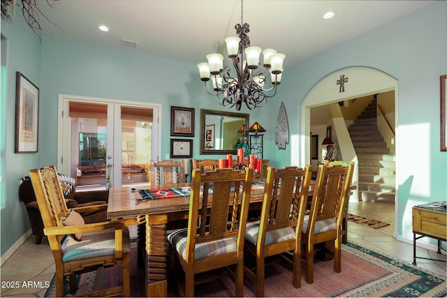 dining space featuring a notable chandelier, french doors, and tile patterned floors