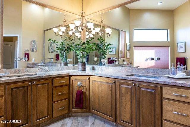 bathroom featuring hardwood / wood-style floors, an inviting chandelier, and vanity