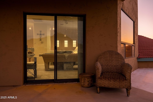 exterior entry at dusk with a patio area