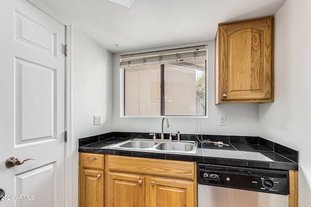 kitchen featuring dishwasher, a textured ceiling, and sink