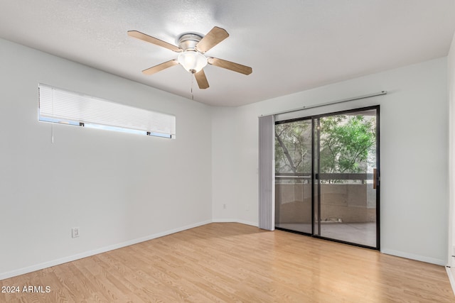 unfurnished room with a textured ceiling, light hardwood / wood-style floors, and ceiling fan