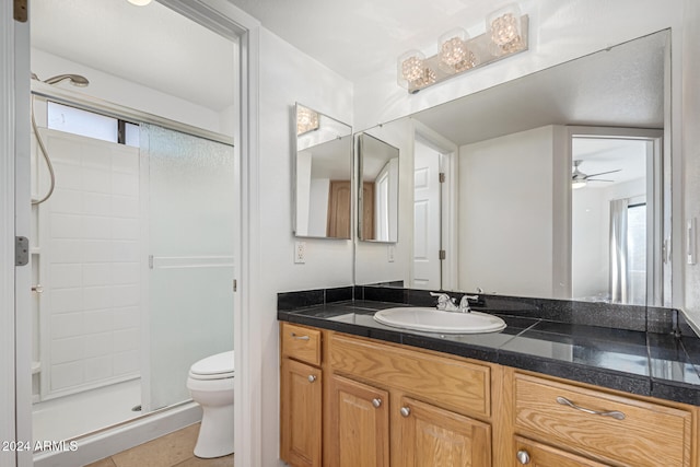 bathroom with ceiling fan, walk in shower, tile patterned floors, toilet, and vanity