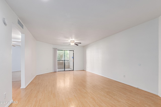 empty room with ceiling fan and light hardwood / wood-style floors