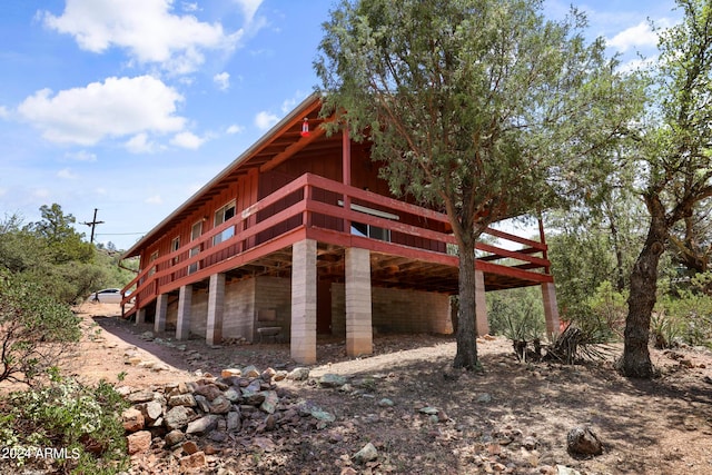 view of side of property featuring a wooden deck