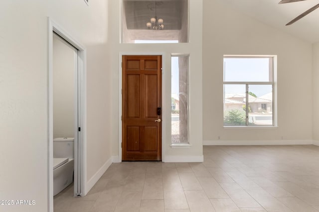 7179 W Surrey Ave, Peoria, AZ 85381 - foyer entrance featuring baseboards, ceiling fan, light tile patterned flooring, and high vaulted ceiling