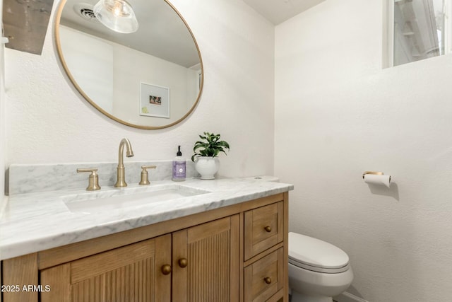 bathroom with vanity and toilet