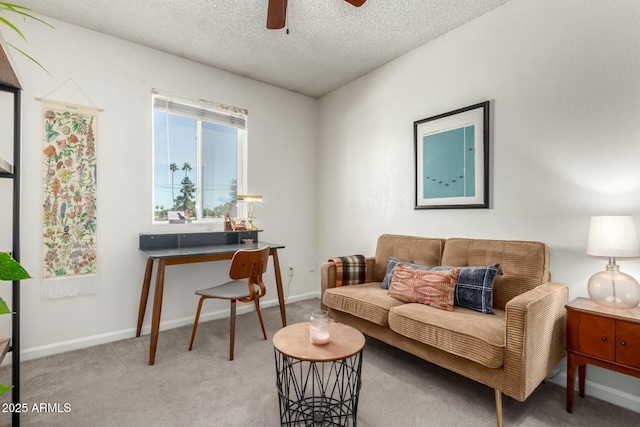 interior space with ceiling fan, light colored carpet, and a textured ceiling