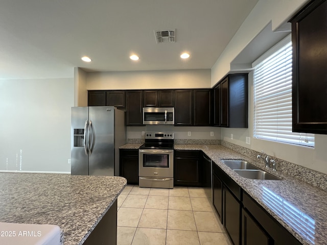 kitchen featuring light tile patterned floors, recessed lighting, visible vents, appliances with stainless steel finishes, and a sink