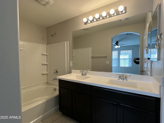 bathroom featuring double vanity, ceiling fan, a sink, and tile patterned floors