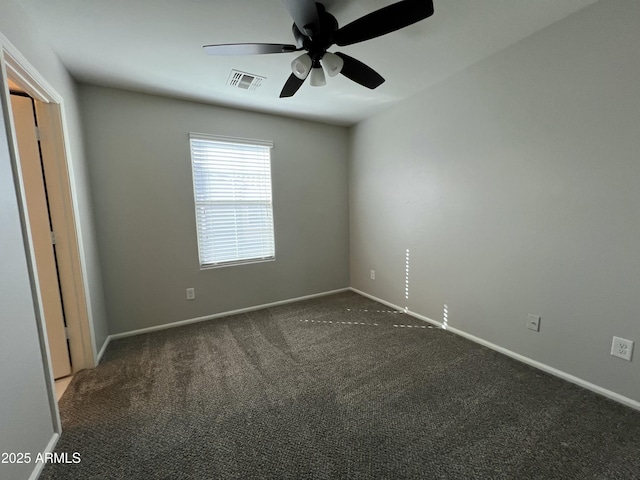 empty room featuring a ceiling fan, carpet flooring, visible vents, and baseboards