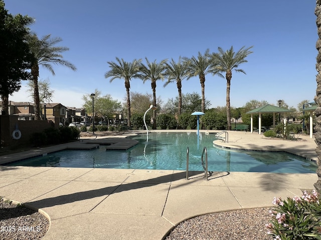 community pool with a patio area and a gazebo