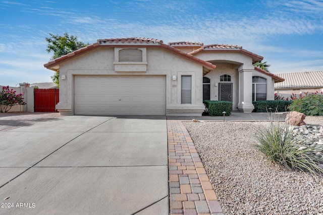 mediterranean / spanish-style house with a garage