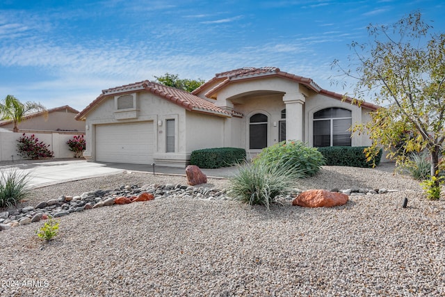 mediterranean / spanish-style home featuring a garage