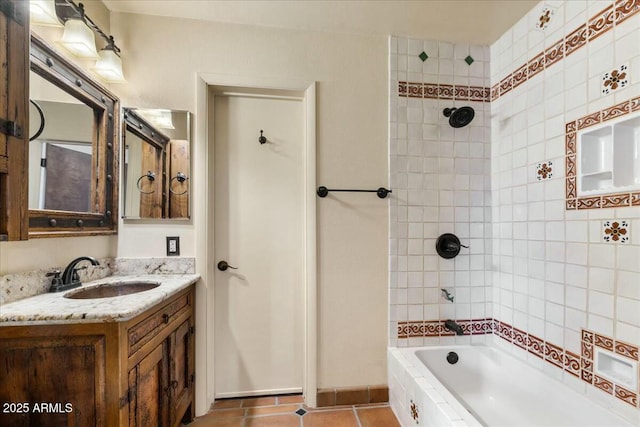 bathroom with vanity, tiled shower / bath, and tile patterned floors