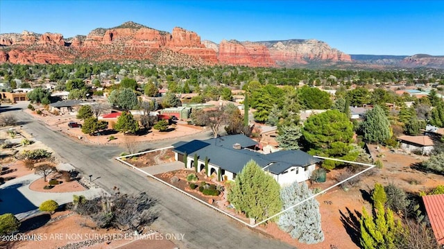 drone / aerial view featuring a residential view and a mountain view