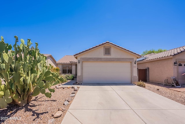 645 W Kingman Loop, Casa Grande, AZ 85122 - view of front of property featuring stucco siding, concrete driveway, a tiled roof, and a garage