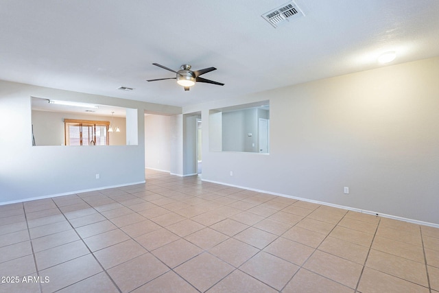 645 W Kingman Loop, Casa Grande, AZ 85122 - unfurnished room with a ceiling fan, baseboards, and light tile patterned floors