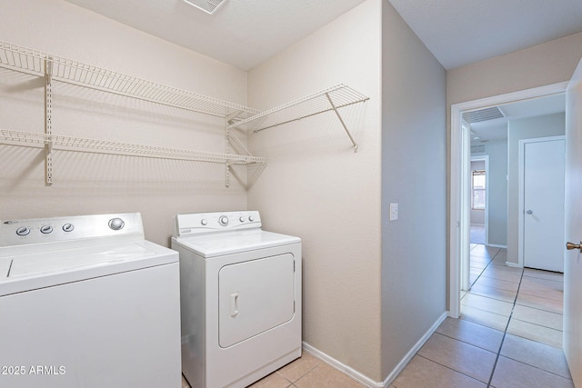 645 W Kingman Loop, Casa Grande, AZ 85122 - washroom featuring washer and dryer, light tile patterned flooring, and baseboards