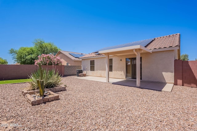 645 W Kingman Loop, Casa Grande, AZ 85122 - rear view of property with stucco siding, solar panels, a fenced backyard, and a tiled roof