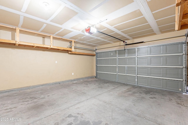 645 W Kingman Loop, Casa Grande, AZ 85122 - garage featuring a garage door opener and baseboards