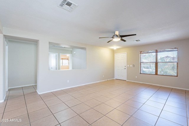 645 W Kingman Loop, Casa Grande, AZ 85122 - spare room with ceiling fan, healthy amount of natural light, light tile patterned floors, and baseboards