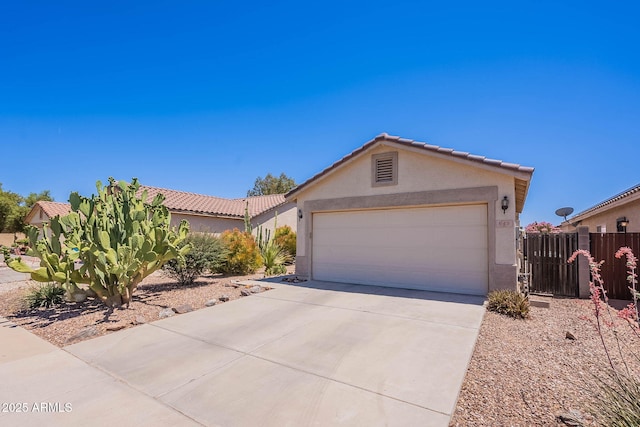 645 W Kingman Loop, Casa Grande, AZ 85122 - view of front of house with stucco siding, concrete driveway, a tiled roof, and a garage
