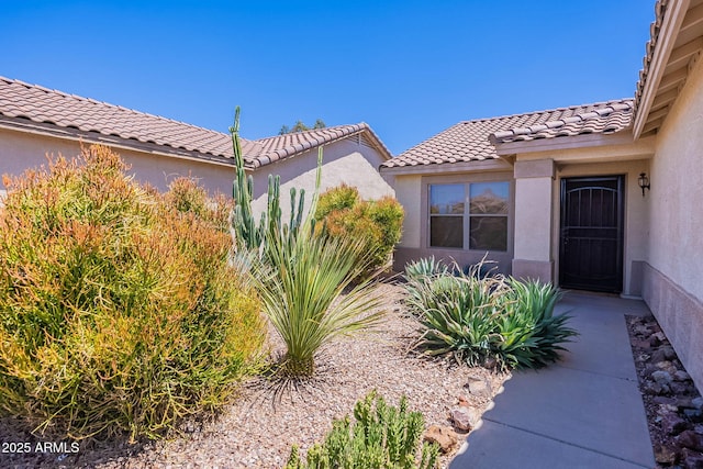 645 W Kingman Loop, Casa Grande, AZ 85122 - view of exterior entry featuring a tiled roof and stucco siding