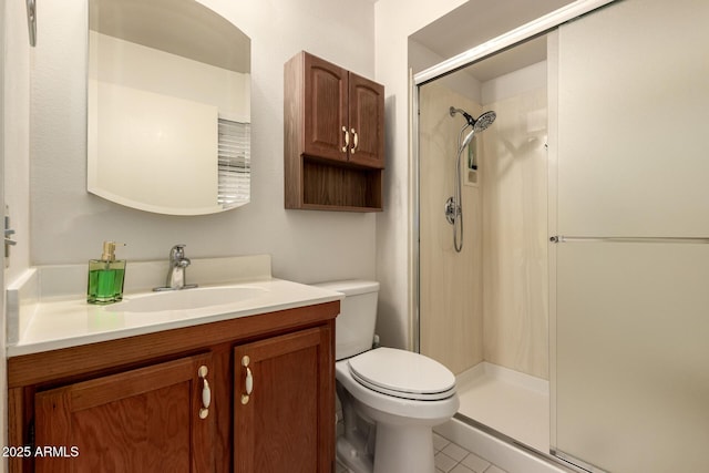 full bathroom with toilet, vanity, a stall shower, and tile patterned flooring