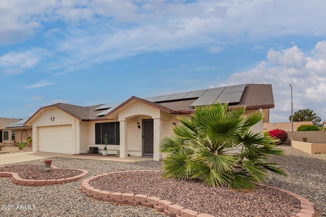 view of front facade featuring roof with shingles, stucco siding, driveway, an attached garage, and roof mounted solar panels