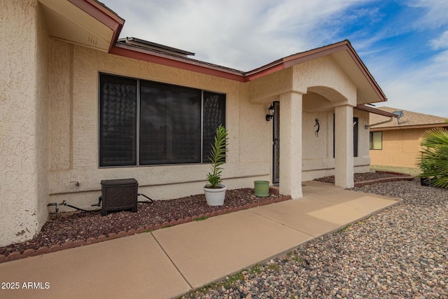 property entrance with stucco siding