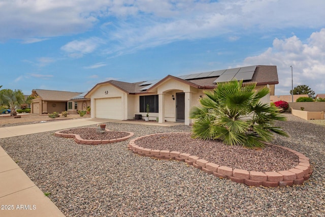 single story home featuring an attached garage, roof mounted solar panels, driveway, and stucco siding