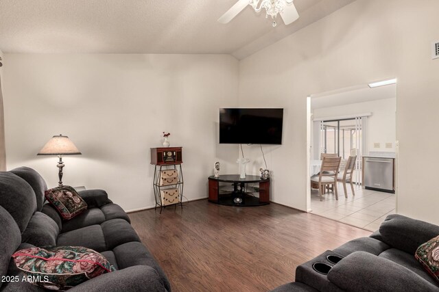 living room with high vaulted ceiling, a ceiling fan, and wood finished floors