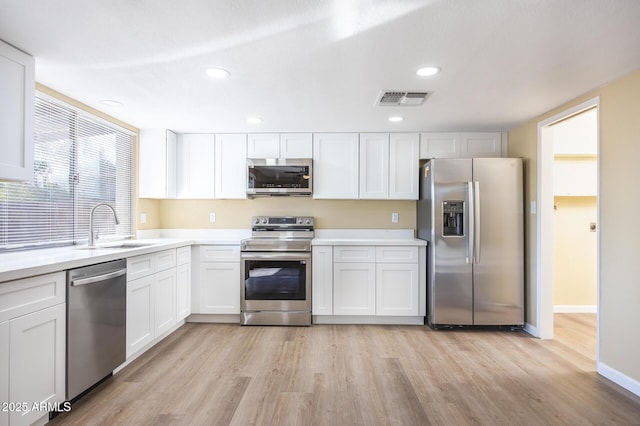 kitchen featuring white cabinetry, sink, and appliances with stainless steel finishes