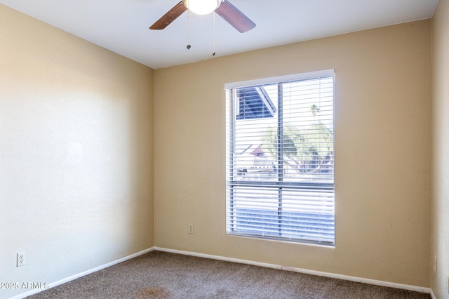 carpeted spare room featuring ceiling fan