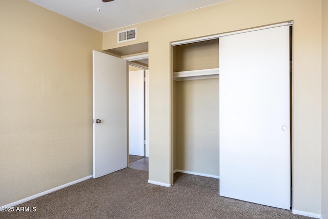 unfurnished bedroom featuring carpet flooring and a closet