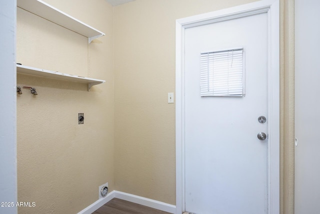 clothes washing area with dark wood-type flooring and hookup for an electric dryer