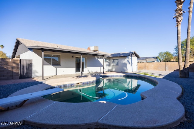 view of pool featuring a patio area and a diving board