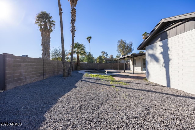 view of yard with a patio area and a hot tub