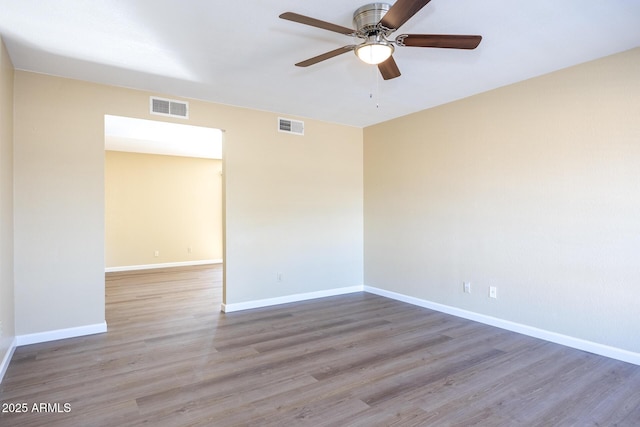 unfurnished room with hardwood / wood-style floors and ceiling fan