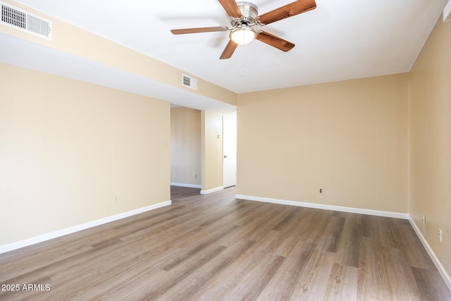 spare room with ceiling fan and light wood-type flooring