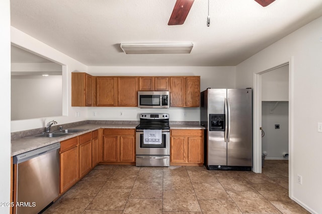6085 S Wilson Dr, Chandler, AZ 85249 - kitchen featuring stainless steel appliances, a sink, and brown cabinetry