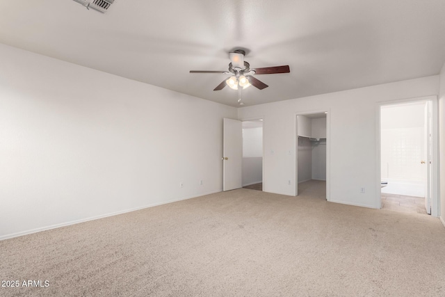 6085 S Wilson Dr, Chandler, AZ 85249 - unfurnished bedroom with light colored carpet, a walk in closet, baseboards, a closet, and a ceiling fan