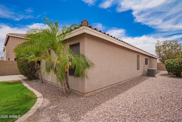 6085 S Wilson Dr, Chandler, AZ 85249 - view of side of property featuring central AC, stucco siding, and a tile roof