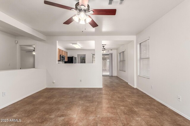 6085 S Wilson Dr, Chandler, AZ 85249 - unfurnished living room featuring ceiling fan, tile patterned floors, and baseboards