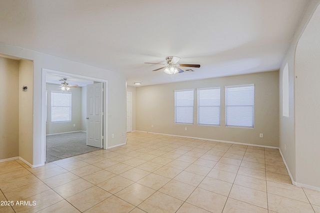 empty room with light tile patterned floors and ceiling fan