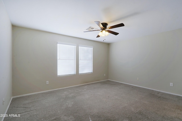 carpeted spare room with ceiling fan