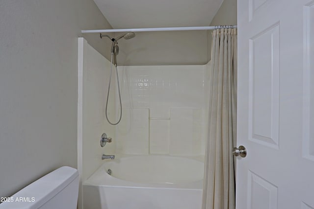 bathroom with shower / tub combo and toilet